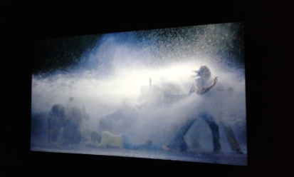 Bill Viola, The Raft, May 2004, video/sound installation. Color high-definition video projection on wall in a darkened space; 5.1 channels of surround sound; 10:33 minutes. Videostill/installation view at the National Portrait Gallery.